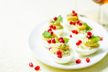 Blue cheese deviled eggs with pomegranate