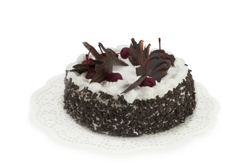 Round chocolate cake with cherries isolated on white background