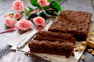 American chocolate cake with walnut on a dark background