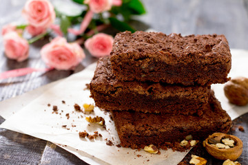 American chocolate cake with walnut on a dark background