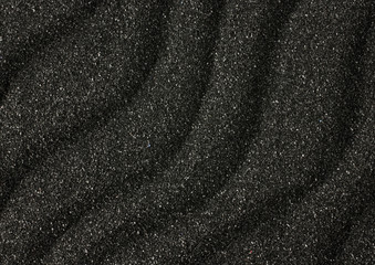 Black sand waves texture as background