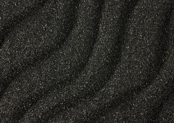 Black sand waves texture as background