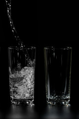 Water is poured into the two cups