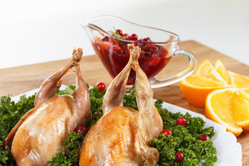 Carcasses of quail roasted with cranberry and parsley