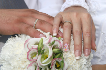 the hands of the bride and bridesmaid wedding bouquet