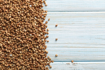 Buckwheat seeds on a blue wooden table