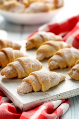 Fresh homemade croissants on a blue wooden table