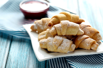 Fresh homemade croissants on a blue wooden table