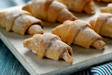 Fresh homemade croissants on a blue wooden table