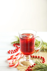 Mulled wine in glass on white wooden table