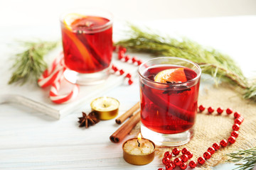 Mulled wine in glass on white wooden table