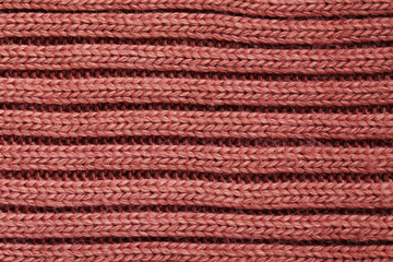 Knitted woolen fabric background, close up