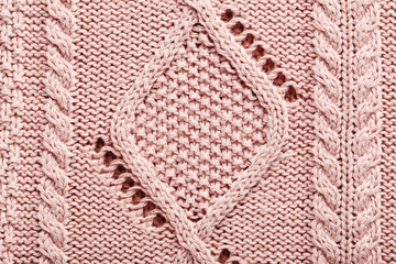 Knitted woolen fabric background, close up