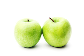 Two green green apple isolated on a white background