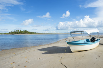 Brazilian boat landed on the shore of a rustic beach on a remote island off the coast of Bahia Nordeste Brazil