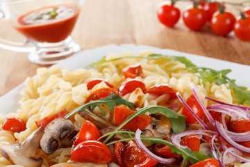 Pasta with mushrooms, cherry tomatoes and tomato sauce, italian food. Closeup