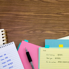 Hindi; Learning New Language Writing Words on the Notebook