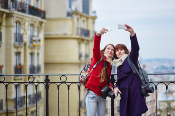 girls in Paris taking selfie