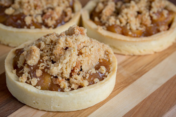 Small Apple Tart Desserts on wood cutting board
