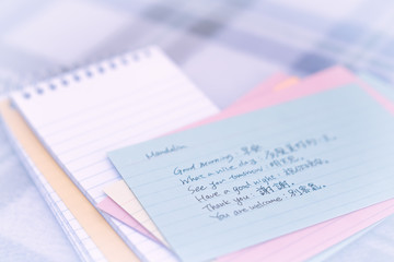 Mandarin; Learning New Language Writing Greetings on the Noteboo