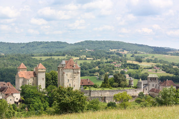 Fototapeta na wymiar The village of Curemonte, Lot , France with its three medieval chateaux in a scenic landscape view, one of the Plus Beaux Villages of France