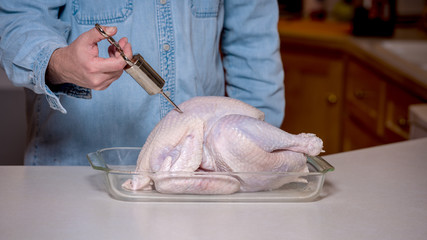 Using a stainless injector to prepare a turkey