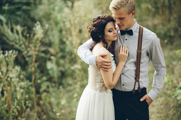 groom gently embracing his bride