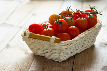 Fresh cherry tomatoes on wooden table. Ingredients for tomato sauce