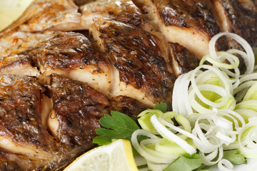 Roasted carp fish with vegetables entirely. Traditional Christmas menu.