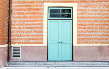 Blue door at orange brick wall,exterior building