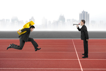 One man using speaker direct another carrying dollar sign runnin