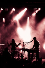 Lights Smoke and Silhouettes With People on a Stage