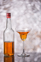 wine glass with burning alcohol on black background