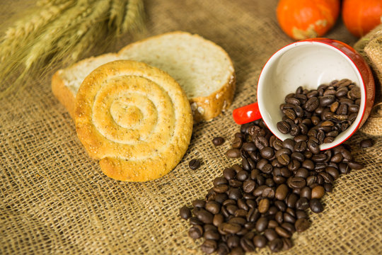 Coffee and bread on cloth background