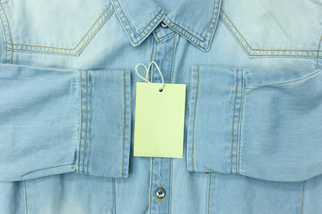 Blue jean shirt with empty tag for background. Can use for marketing your product.