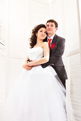 Naklejka premium Wedding couple holding hands and hugging.