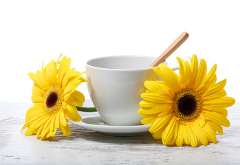 Coffee cup with yellow gerberas