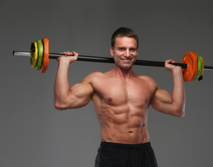 Fototapeta na wymiar Middle age muscular man holding barbell.