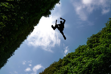 Man jumping over bushes