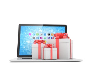 Gift box with ribbon bow on laptop keyboard