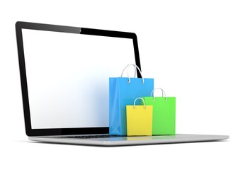 laptop and  shopping pags on white background