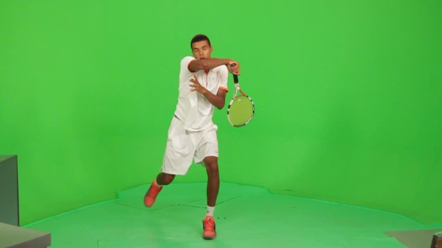 Professional tennis player makes different types of shots on a green screen.Session with professional tennis player