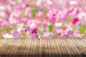 Wood table top on pink flower bokeh background