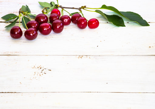 Cherries on wood background