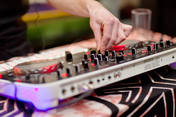 Fototapeta na wymiar DJ mixing music on console at the night club