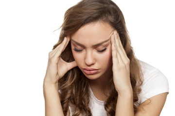 pretty girl with a strong headache on a white background