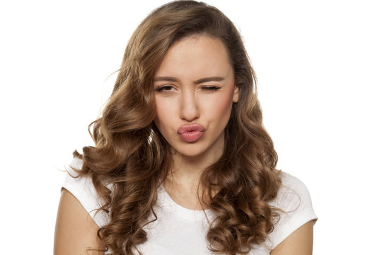 winking beautiful young woman with pursed lips