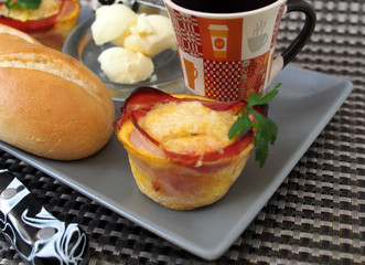 Creative breakfast – egg muffins with bacon, coffee, white bread, butter