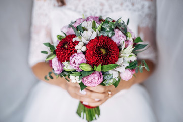 bride holding a bouquet of flowers in a rustic style, wedding bouquet
