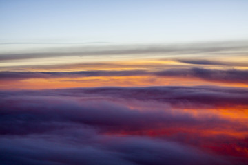 Flight Above the Cloud Layer during Vibrant Sunset